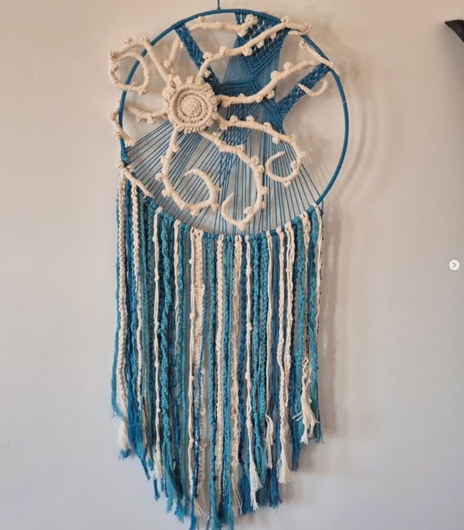 A shiek detailed macrame black shoulder bag with decorative heart patterns and inside bag lining
