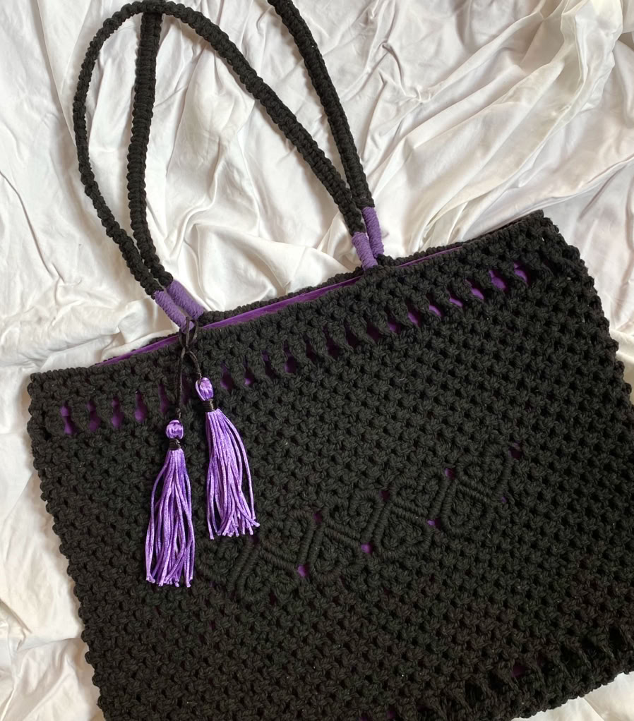 A shiek detailed macrame black shoulder bag with decorative heart patterns and inside bag lining